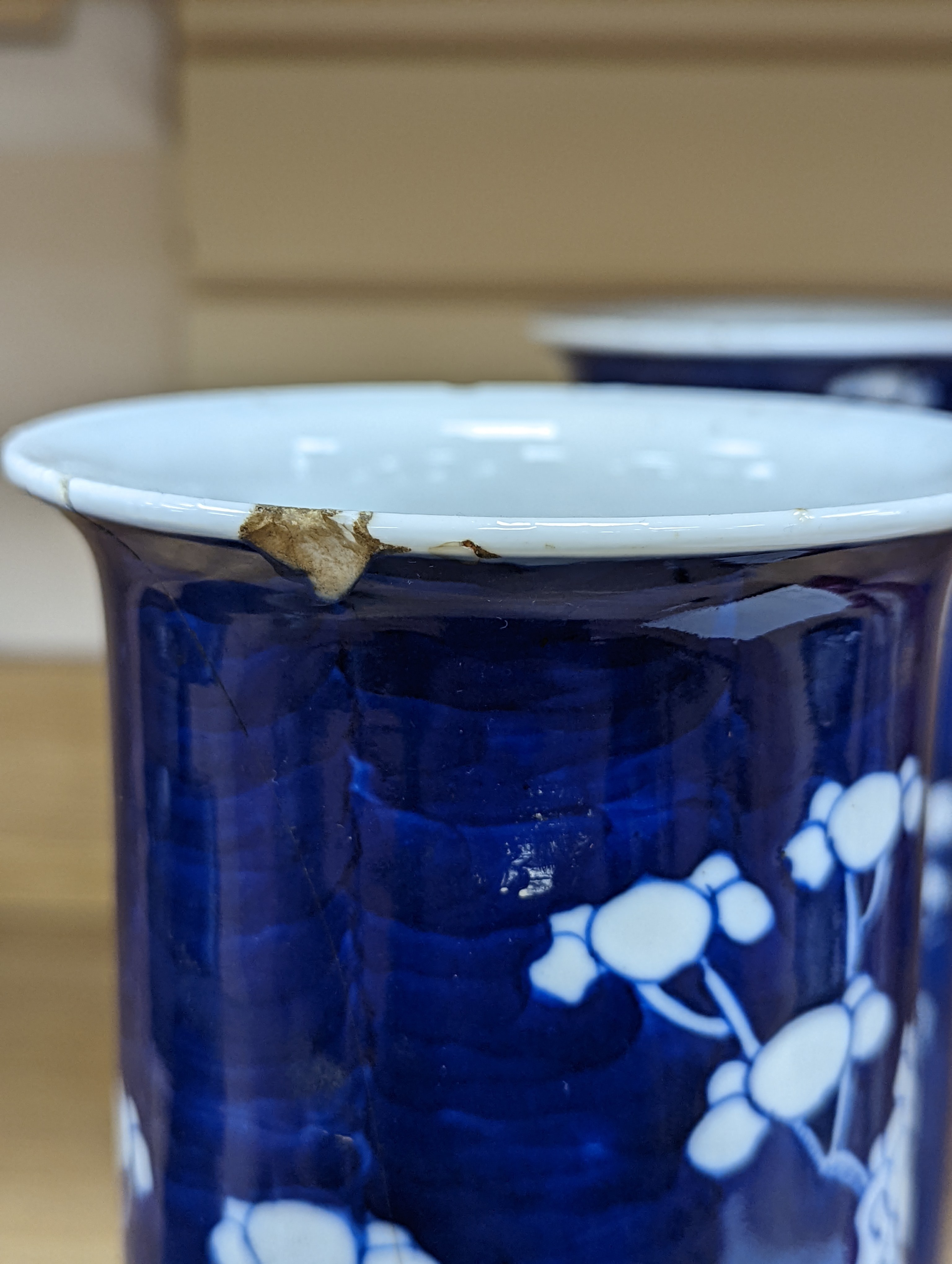 An 18th century Chinese famille rose mug, a Chinese Imari tea caddy and two Chinese blue and white sleeve vases 30cm (4)